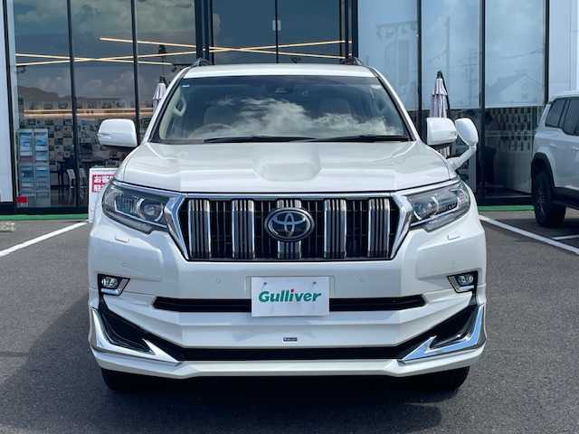 トヨタ ランドクルーザー プラド TX 長崎県 2018(平30)年 7.4万km ホワイトパールクリスタルシャイン 純正メモリーナビ/CD/DVD/BT/フルセグTV/バックカメラ/ウッドコンビハンドル（OP）/モデリスタフロントエアロ/トヨタセーフティセンス/レーダークルーズコントロール/レーンキープアシスト/ステアリングスイッチ/LEDヘッドライト/オートマチックハイビーム/ルーフレール/ドライブレコーダー/社外17インチAW/ビルトインETC