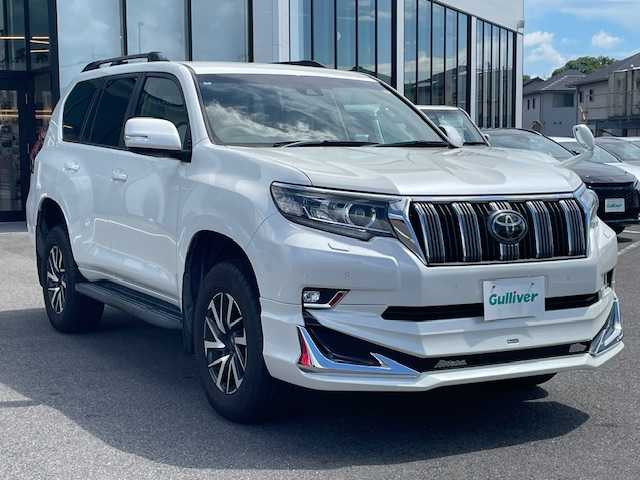 トヨタ ランドクルーザー プラド TX 長崎県 2018(平30)年 7.4万km ホワイトパールクリスタルシャイン 純正メモリーナビ/CD/DVD/BT/フルセグTV/バックカメラ/ウッドコンビハンドル（OP）/モデリスタフロントエアロ/トヨタセーフティセンス/レーダークルーズコントロール/レーンキープアシスト/ステアリングスイッチ/LEDヘッドライト/オートマチックハイビーム/ルーフレール/ドライブレコーダー/社外17インチAW/ビルトインETC