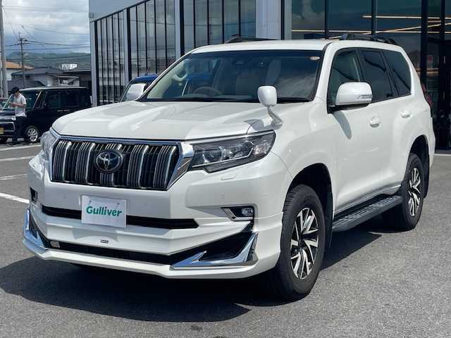 トヨタ ランドクルーザー プラド TX 長崎県 2018(平30)年 7.4万km ホワイトパールクリスタルシャイン 純正メモリーナビ/CD/DVD/BT/フルセグTV/バックカメラ/ウッドコンビハンドル（OP）/モデリスタフロントエアロ/トヨタセーフティセンス/レーダークルーズコントロール/レーンキープアシスト/ステアリングスイッチ/LEDヘッドライト/オートマチックハイビーム/ルーフレール/ドライブレコーダー/社外17インチAW/ビルトインETC