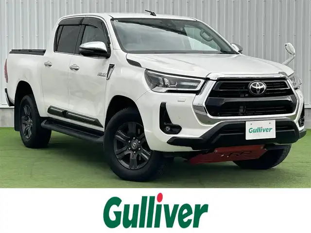 トヨタ ハイラックス Z 香川県 2021(令3)年 2.6万km スーパーホワイトⅡ 登録時走行距離：25681km/トヨタセーフティーセンス/→プリクラッシュセーフティ/→先行車発進アラート/→レーントレーシングアシスト/→レーダークルーズコントロール/→レーンキープアシスト/ALPINE11型ディスプレイオーディオ/→HDMI接続可能/→AppleCarPlay/AndroidAuto対応/バックカメラ/革巻きステアリング/ステアリングリモコン/ダウンヒルアシストコントロール/LEDヘッドライト/オートハイビーム/オートライト/ドライブレコーダー/純正17インチアルミホイール/スペアキー/スマートキー/プッシュスタート