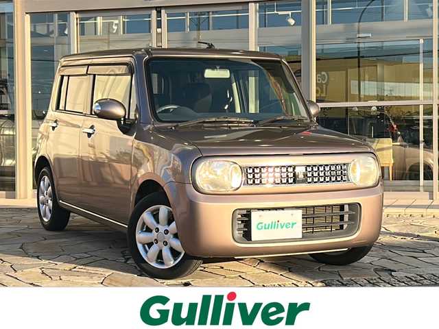 スズキ ラパン 10thアニバーサリーリミテッド 静岡県 2012(平24)年 9.4万km 茶 社外ナビ/シートヒーターD席/ETC/純正アルミホイール/純正フロアマット/スマートキー/スペアキー×１/プッシュスタート/オートエアコン/ハロゲンヘッドライト/Wエアバッグ/ABS/パワーウィンドウ/パワーステアリング