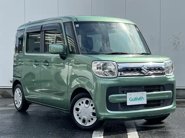 スズキ スペーシア HYBRID X 三重県 2018(平30)年 6.4万km ツールグリーンパールメタリック 4WD/純正ナビ（Bluetooth/DVD/CD/地デジTV/AM/FM/SD）/ETC/両側パワースライドドア/シートヒーター（前席）/スペアキー/セーフティサポート（デュアルセンサーブレーキサポート/誤発進抑制/車線逸脱警報/ふらつき警報/先行車発進お知らせ/ハイビームアシスト/後退時ブレーキサポート/後方誤発進抑制/リアパーキングセンサー）/ブラック内装/光沢アイボリーインパネ加飾/チルトステアリング/オートエアコン/エコクール/リアヒーターダクト/スリムサーキュレーター/ファブリックシート/ボックス付アームレスト(前席中央)/シートリフター(運転席）/ストラップ付左右独立スライドシート（リア）/ロールサンシェード（リアドア）/アクセサリーソケット（後席右側）/ラゲッジルームランプ/後方視界支援ミラー/純正フロアマット