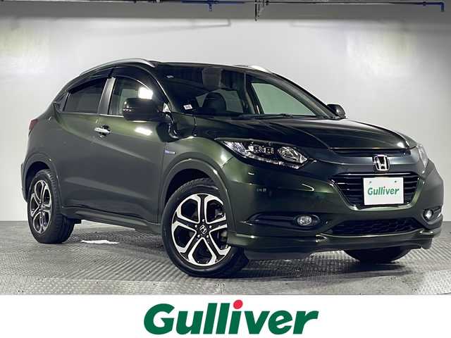 ホンダ ヴェゼル ハイブリッド Z 沖縄県 2014(平26)年 7.9万km ミスティックグリーンパール 県外仕入　/禁煙車　/純正７インチナビ[VXM155VFi]/（ＢＴ，フルセグ，ＣＤ／ＤＶＤ，ラジオ）　/バックカメラ　/ルーフレール　/ハーフレザーシート　/運転席シートヒーター　/クルーズコントロール　/パドルシフト　/オートライト　/ETC/純正フロアマット/純正ドアバイザー/電子パーキングブレーキ/ＬＥＤヘッドライト/純正17インチアルミホイール