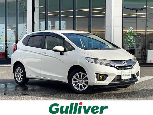 ホンダ フィット 13G Lパッケージ 新潟県 2013(平25)年 7.1万km プレミアムホワイトパール ４WD/純正メモリーナビ/(BT/AM/FM/ワンセグTV)/バックカメラ/社外15インチアルミ/ETC/電格ミラー/プッシュスタートエンジン/純正フロアマット/保証書/スペアキー
