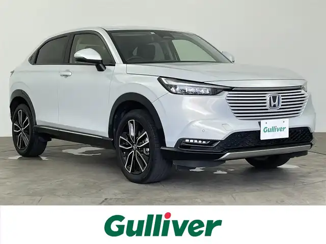 ホンダ ヴェゼル ハイブリッド e:HEV Z 大分県 2022(令4)年 5.1万km プレミアムサンライトホワイトパール ホンダセンシング/・衝突軽減ブレーキ/・渋滞追従機能付アダプティブクルーズコントロール/・車線維持支援システム/・路外逸脱抑制機能/・パーキングセンサーシステム/・オートハイビーム/・誤発進抑制機能/後方誤発進抑制機能/・先行車発進お知らせ機能/・歩行者事故低減ステアリング/・標識認識機能/純正ナビ/（フルセグ/CD/Bluetooth/AM/FM/carplay)/バックカメラ/パワーテールゲート/LEDヘッドライト/ハーフレザーシート/前席シートヒーター/ステアリングヒーター/パドルシフト/オートブレーキホールド/電動パーキングブレーキ/純正18インチアルミホイール/ETC2.0/保証書・取扱説明書