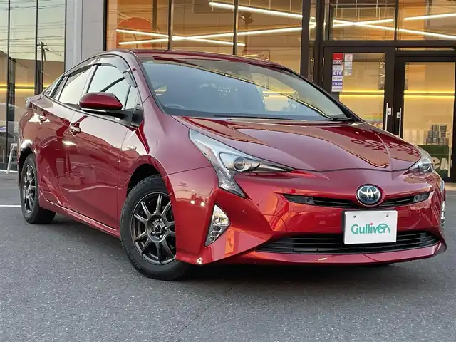 トヨタ プリウス A ツーリングセレクション 宮城県 2016(平28)年 10.3万km エモーショナルレッド 登録時走行距離102331km/黒革シート/トヨタセーフティセンス/PCS・LDA・ACC・BCM・ICS・AHB/ヘッドアップディスプレイ/パーキングアシスト/純正９インチナビ/CD・DVD・Bluetooth/フルセグTV/バックカメラ/プッシュスタート/スマートキー×２/ステアリングリモコン/ビルトインETC/前席シートヒーター/横滑り防止装置/LEDヘッドライト/フォグランプ/ハンドルカバー/ドアバイザー