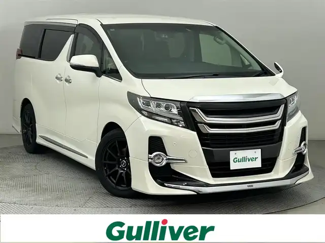 トヨタ アルファード S Cパッケージ 道央・札幌 2016(平28)年 7.1万km ラグジュアリーホワイトパールクリスタルシャインガラスフレーク ・４WD/・寒冷地仕様/・モデリスタエアロ/・モデリスタグリル/・純正SDナビ/　CD／DVD／Bluetooth／フルセグ/・純正フリップダウンモニター/・純正ビルトインETC/・社外前後ドライブレコーダー/・純正エンジンスターター/・両側パワースライドドア/・電動リアゲート/・クルーズコントロール/・アイドリングストップ/・横滑り防止装置/・ステアリングヒーター/・前後コーナーセンサー/・オートブレーキホールド/・パワーシート/・運転席シートメモリー/・自動防眩ミラー/・LEDヘッドライト/・フォグライト/・スマートキー/・プッシュスタート