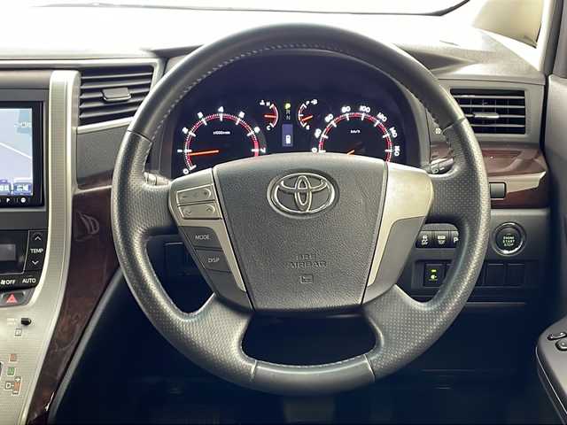 トヨタ ヴェルファイア 2．4Z 兵庫県 2012(平24)年 10.6万km ホワイトパールクリスタルシャイン ・純正ナビ/CD/DVD/MSV/BT/TV/・バックカメラ/・前方ドライブレコーダー/・左右独立エアコン/・MTモード付AT/・ビルトインETC/・革巻ステアリング/・ステアリングスイッチ/・nanoe/・クリアランスソナー/・両側パワースライドドア/・トランクイージークローザー/・オールオートパワーウィンドウ/・横滑り防止装置/・ウインカーミラー/・プッシュスタート/・後席エアコン/・HIDヘッドライト/・フォグランプ/・電動格納ミラー/・スマートキー/・スペアキー/・純正フロアマット/・純正アルミホイール/・取扱説明書/・保証書