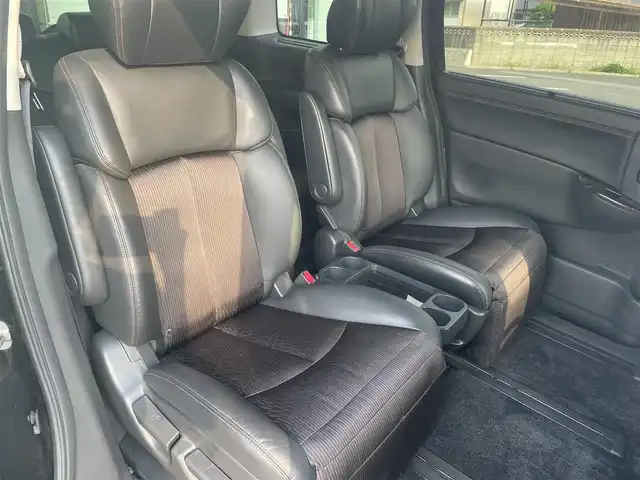 日産 エルグランド 250ハイウェイスター 愛媛県 2015(平27)年 6.4万km ファントムブラック 純正ナビ（Bluetooth/CD/DVD/AUX/フルセグTV)/リアエンターテインメント/バックカメラ/ビルドインETC/前方ドライブレコーダー/両側パワースライドドア/ハーフレザーシート/オットマン/100V充電/クルーズコントロール/純正18インチアルミホイール/純正フロアマット/純正ドアバイザー/LEDヘッドライト/フォグランプ/ABS/横滑り防止装置