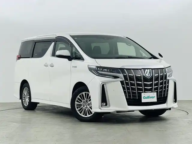 トヨタ アルファードハイブリット SR Cパッケージ 福島県 2019(令1)年 2.3万km ホワイトパールクリスタルシャイン フリップダウンモニター/・純正SDナビゲーション/型式：NSZt-Y68T/【CD/DVD/Bluetooth/フルセグTV】/・バックカメラ/・ETC2.0/・前後ドライブレコーダー/プリクラッシュセーフティ/レーントレーシングアシスト/アダプティブクルーズコントロール/クリアランスソナー/パーキングサポートブレーキ/ロードサインアシスト/電子パーキングブレーキ/・ブレーキオートホールド/アイドリングストップ/両側パワースライドドア/・パワーバックドア/コンビステアリング/・ステアリングスイッチ/・ステアリングヒーター/レザーシート/・運転席＋助手席パワーシート/・運転席メモリーシート/・運転席＋助手席シートヒーター/・運転席＋助手席エアシート/・オットマン/LEDヘッドライト/・オートライト/・フロントフォグライト/ABS/横滑り防止装置/盗難防止装置/純正フロアマット/ドアバイザー/プッシュスタート/・スマートキー/・スペアキー