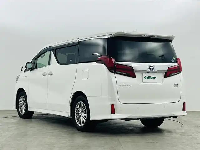 トヨタ アルファードハイブリット SR Cパッケージ 福島県 2019(令1)年 2.3万km ホワイトパールクリスタルシャイン フリップダウンモニター/・純正SDナビゲーション/型式：NSZt-Y68T/【CD/DVD/Bluetooth/フルセグTV】/・バックカメラ/・ETC2.0/・前後ドライブレコーダー/プリクラッシュセーフティ/レーントレーシングアシスト/アダプティブクルーズコントロール/クリアランスソナー/パーキングサポートブレーキ/ロードサインアシスト/電子パーキングブレーキ/・ブレーキオートホールド/アイドリングストップ/両側パワースライドドア/・パワーバックドア/コンビステアリング/・ステアリングスイッチ/・ステアリングヒーター/レザーシート/・運転席＋助手席パワーシート/・運転席メモリーシート/・運転席＋助手席シートヒーター/・運転席＋助手席エアシート/・オットマン/LEDヘッドライト/・オートライト/・フロントフォグライト/ABS/横滑り防止装置/盗難防止装置/純正フロアマット/ドアバイザー/プッシュスタート/・スマートキー/・スペアキー