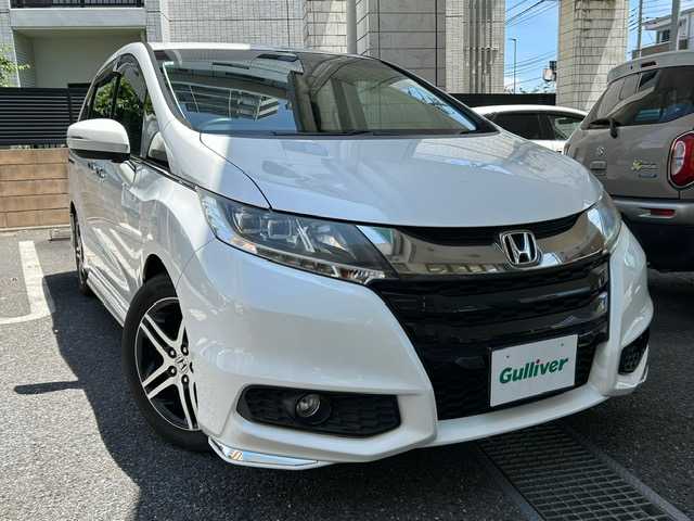 ホンダ オデッセイ アブソルート 20thアニバーサリー 東京都 2015(平27)年 1.2万km ホワイトオーキッドパール 登録時走行11337km/ワンオーナー/ホンダセンシング/・CMBS（衝突軽減ブレーキ）/・誤発進抑制機能/・先行車発進お知らせ機能/・アダプティブクルーズコントロール/・LKAS（車線維持支援システム）/・路外逸脱抑制機能/・標識認識機能/インターナビ対応SDナビ/フルセグTV/バックカメラ/両側パワースライドドア/ビルトインETC/ドライブレコーダー/ハーフレザーシート（合皮）/D席パワーシート/LEDライト/H30.R2.4.6年記録簿/保証書・取説/スペアキー