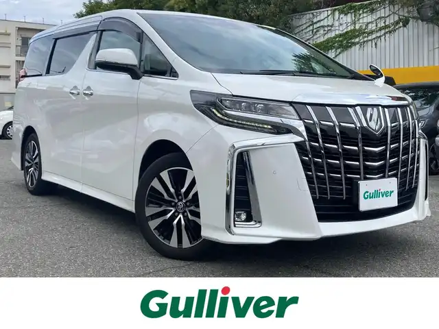 トヨタ アルファード S Cパッケージ 兵庫県 2021(令3)年 6.4万km ホワイトパールクリスタルシャイン ディスプレイオーディオ/FM/AM/Bluetooth/Miracast/フルセグTV/両側電動スライドドア/パワーバックドア/革シート/シートヒーター/エアシート/レーンキープアシスト/クリアランスソナー/プリクラッシュセーフティー/道路標識認識アシスト/電動シート/オットマン/ハンドルヒーター/ウッドコンビステアリング/電動格納ミラー/シートメモリ/プッシュスタートボタン/ステアリングスイッチ/MTモード付AT/ETC/LEDヘッドライト