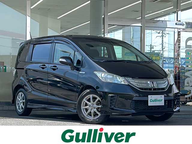 ホンダ フリード ハイブリット ジャストセレクション 福島県 2014(平26)年 10.6万km プレミアムスパークルブラックパール 105512km/社外SDナビ/（BT接続/フルセグTV/DVD/CD/AM/FM）/社外フリップダウンモニター/クルーズコントロール/両側パワースライドドア/ETC/純正フロアマット/社外AW/社外AWスタッドレスタイヤ４本車載/電格ミラー/ウィンカーミラー/HIDヘッドライト/三列シート/ダブルエアバック/横滑り防止装置/保証書/取扱説明書