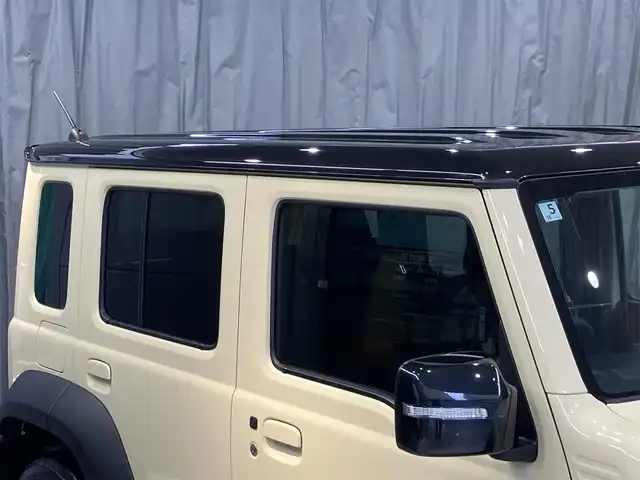 スズキ ジムニー ノマド FC 東京都 2025(令7)年 0.2万km ベージュⅡ 純正メモリナビ(CN-HE02WD)/（TV・Bluetooth・DVD・CD）/バックカメラ/セーフティサポート/・ディユアルカメラブレーキサポート/・誤発進抑制機能/・後退時ブレーキサポート/・後方誤発進抑制機能/・車線逸脱警告機能/・ふらつき警告機能/・先行車発進お知らせ機能/・ハイビームアシスト/・アダクティブクルーズコントロール/・標識認識機能/ワンオーナー /プッシュスタート/アイドリングストップ/フロアマット/シートヒーター /LEDヘッドライト　・フォグランプ/電動格納ミラー/保証書・取扱説明書・スペアキー