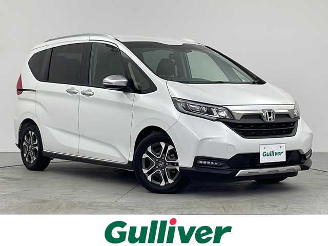 ホンダ フリード クロスター 愛知県 2022(令4)年 0.8万km プラチナホワイトパール KENWOOD製ナビ/【Bluetooth/USB/AM/FM/TV/CD/AUX】/両側パワースライドドア/バックカメラ/ホンダセンシング/・衝突被害軽減ブレーキ/・レーンアシスト/・盗難防止装置/・横滑り防止装置/・コーナーセンサー/・レーダークルーズコントロール/アイドリングストップ/前席シートヒーター/ハーフレザーシート/カーテンエアバック/ETC/純正フロアマット/スペアキー/LEDオートライト/ルーフレール/純正15インチアルミホイール/電動格納ミラー