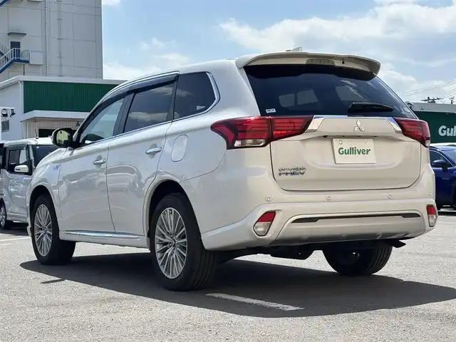 三菱 アウトランダー ＰＨＥＶ G プレミアムパッケージ 東京都 2019(平31)年 11.5万km シルキーホワイト S-AWC(アクティブヨー/アクティブスタビリティコントロール統合制御）/充電機能（普通/急速）/充電口ロック（ドアロック連動）/eアシスト（予防安全技術）/パワーバックドア　/ボディ同色ミラー（電動格納機能/ヒーター/ウィンカー付）/モーフィンブラックインパネ加飾/ブラック天井/ハイコントラストメーター（自発光式アナログメーター/マルチインフォメーションディスプレイ）/シルバー加飾付革巻きステアリングホイール/ステアリングヒーター/ステアリングスイッチ（オーディオ/アダプティブクルーズコントロール）/パドルシフト/SRSエアバック（運転席/助手席/サイド/ニー/カーテン）/左右独立温度調節機能オートエアコン/リアヒーターダクト/パワーシート（運転席/助手席）/シートヒーター（運転席/助手席）/キーレスオペレーションシステム/パワースイッチ/MMCS/６スピーカー/マルチアラウンドモニター/AC電源100V/1500W/リモートコントロール（タイマー充電/空調/車両情報/車両操作）/ディスプレイオーディオ