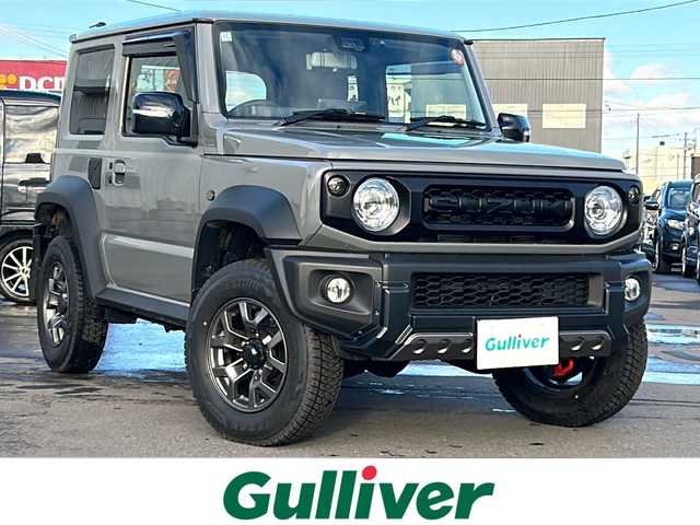スズキ ジムニー シエラ JC 道北・旭川 2024(令6)年 0.6万km ミディアムグレー /４WD//禁煙車//ワンオーナー//衝突軽減システム//レーンキープアシスト//クルーズコントロール//社外ディスプレイオーディオ/BT/ラジオ/アンドロイドオート/アップルカープレイ//バックカメラ//社外ミラー型ドライブレコーダー//社外スロットルコントローラー//アイドリングストップ//オートエアコン//ミラーヒーター//前席シートヒーター//革巻きステアリング//ステアリングスイッチ//オートライト//LEDヘッドライト//フォグランプ//ミラーウィンカー//ヘッドライトウォッシャー//電動格納ミラー//ドアバイザー//社外テールランプ//社外AWマッドタイヤ積込み//保証書//取説