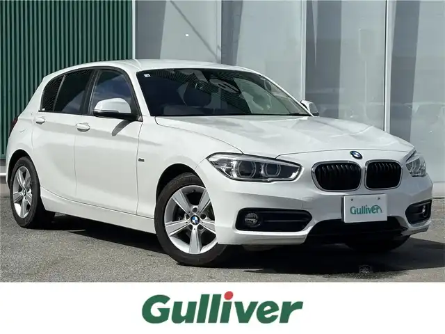 ＢＭＷ １１８ｄ スポーツ 福岡県 2016(平28)年 6万km 白 衝突被害軽減システム/LEDオートライト・オートハイビーム/横滑り防止装置/レーンアシスト/クルーズコントロール/パーキングアシスト/純正16インチアルミホイール/純正フロアマット/純正ナビ/オットマン/電動リアゲート/Bluetooth接続/CD・CDチェンジャー/ETC/スマートキー/ターボエンジン