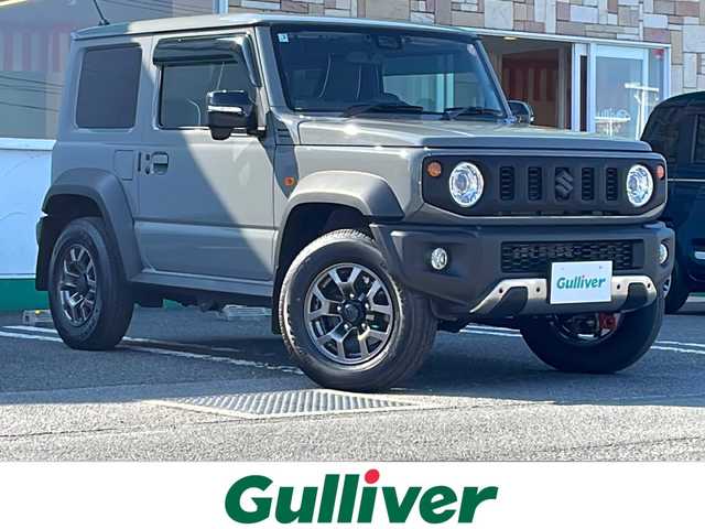 スズキ ジムニー シエラ JC 徳島県 2025(令7)年 0.2万km ミディアムグレー カスタムフィットスピーカースピーカー【KFC-RS165】/ロッソモデロマフラー（純正品あり）/ショックアブソーバー（純正品あり）/ドアプロテクター/7インチナビ【KXM-E503W】/（Bluetooth/フルセグ/CD/DVD/USB/ipod）/黒革シートカバー/シートヒーター（D+N席）/ステアリングヒーター/クルーズコントロール/レーンキープアシスト/ダウンヒルアシストコントロール/デジタルインナーミラー/背面タイヤ（カバー付き）/LEDヘッドライト/LEDフォグランプ/ヘッドライトウォッシャー/オートマチックハイビーム/サイドミラーヒーター/ETC/前後ドライブレコーダー/純正AW/社外フロアマット/ドアバイザー/ドリンクホルダー（D+N席）/スマホスタンド/プッシュスタート/スマートキー/スペアキー/取扱説明書/保証書/記録簿