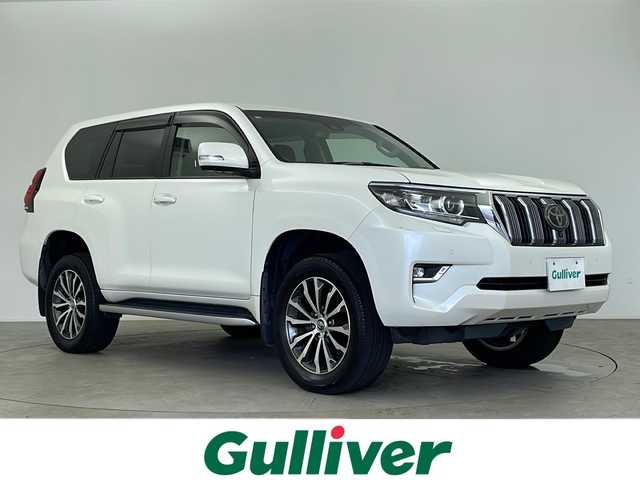 トヨタ ランドクルーザー プラド TX Lパッケージ 鹿児島県 2018(平30)年 4.3万km ホワイトパールクリスタルシャイン メーカーOPナビ/（AM/FM/フルセグ/Bluetooth）/パノラミックビューモニター/トヨタセーフティセンス/クリアランスソナー/プリクラッシュセーフティ/先行車発進通知/オートマチックハイビーム/レーンディパーチャーアラート/レーダークルーズコントロール/ブラインドスポットモニター/ETC/前後ドライブレコーダー/LEDヘッドライト/オートライト/フォグランプ/レザーシート/パワーシート（D席＋N席）/シートヒーター（D席＋N席）/シートベンチレーション（D席＋N席）/革巻きステアリング/ステアリングスイッチ/フロアマット/プッシュスタート/スマートキー/スペアキー