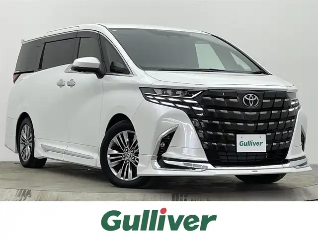 トヨタ アルファードハイブリット Z 宮城県 2023(令5)年 0.9万km プラチナホワイトパールマイカ ４ＷＤ/モデリスタエアロ／マフラー/全周囲カメラ/ルーフスポイラーイルミ/純正ナビ/ヘッドアップディスプレイ/ブラインドスポットモニター/リアクロストラフィックアラート/クリアランスソナー/アダプティブクルーズコントロール/パワーバックドア/両側パワースライドドア/シートヒーター/ベンチレーション/メモリ機能付パワーシート/１００Ｖ電源/ETC2.0/ミラー型前後ドライブレコーダー/フルセグTV/セーフティセンス