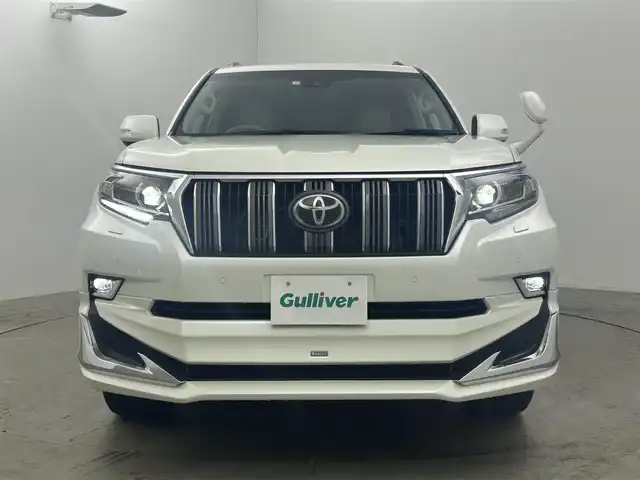 トヨタ ランドクルーザー プラド TX Lパッケージ 岡山県 2023(令5)年 2万km ホワイトパールクリスタルシャイン サンルーフ/モデリスタエアロ（前/後下）/ベージュレザーシート/ルーフレール/純正19インチAW/純正9インチSDナビ/（Bluetooth/フルセグTV)/プリクラッシュセーフティ/レーダークルーズコントロール/踏み間違い防止/オートハイビーム/ＬＥＤヘッドライト（Auto付）/LEDフォグランプ/ビルトインＥＴＣ/バックカメラ/シートヒーター（D/N）/エアシート（D/N）/パワーシート（D/N）/コンビハンドル/ISOFIX/ステアリングスイッチ/チルトステアリング/シートリフター/ウインカーミラー