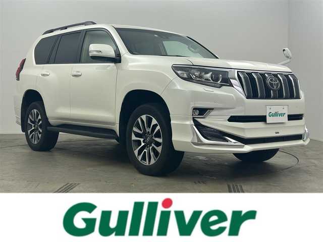 トヨタ ランドクルーザー プラド TX Lパッケージ 道央・札幌 2023(令5)年 2万km ホワイトパールクリスタルシャイン サンルーフ/モデリスタエアロ（前/後下）/ベージュレザーシート/ルーフレール/純正19インチAW/純正9インチSDナビ/（Bluetooth/フルセグTV)/プリクラッシュセーフティ/レーダークルーズコントロール/踏み間違い防止/オートハイビーム/ＬＥＤヘッドライト（Auto付）/LEDフォグランプ/ビルトインＥＴＣ/バックカメラ/シートヒーター（D/N）/エアシート（D/N）/パワーシート（D/N）/コンビハンドル/ISOFIX/ステアリングスイッチ/チルトステアリング/シートリフター/ウインカーミラー
