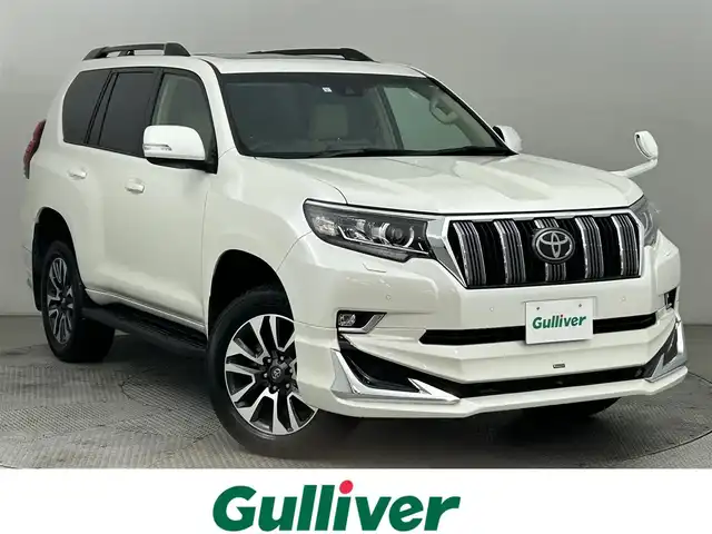 トヨタ ランドクルーザー プラド TX Lパッケージ 道央・札幌 2023(令5)年 2万km ホワイトパールクリスタルシャイン サンルーフ/モデリスタエアロ（前/後下）/ベージュレザーシート/ルーフレール/純正19インチAW/純正9インチSDナビ/（Bluetooth/フルセグTV)/プリクラッシュセーフティ/レーダークルーズコントロール/踏み間違い防止/オートハイビーム/ＬＥＤヘッドライト（Auto付）/LEDフォグランプ/ビルトインＥＴＣ/バックカメラ/シートヒーター（D/N）/エアシート（D/N）/パワーシート（D/N）/コンビハンドル/ISOFIX/ステアリングスイッチ/チルトステアリング/シートリフター/ウインカーミラー