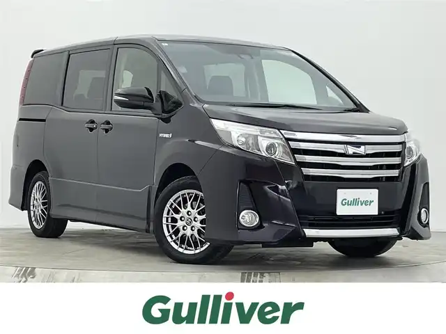 トヨタ ノア ハイブリッド Si 宮城県 2016(平28)年 4.4万km ボルドーマイカメタリック 純正9型ナビ/後席モニター/両側パワースライドドア/プリクラッシュセーフティ/レーンディパーチャーアラート/オートマチックハイビーム/バックモニター/ETC2.0/フロントウィンドウ熱線/LEDヘッドランプ/フォグランプ/フルセグTV/Bluetoothオーディオ/CD/DVD/スマートキー/禁煙車