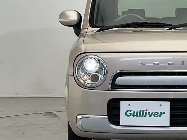 スズキ ラパン ショコラ G 滋賀県 2015(平27)年 6.4万km シャンパンピンクPM 社外ナビ/(CD/ワンセグTV)/ビルトインETC/ドライブレコーダー/レザーシート/HIDヘッドライト/純正フロアマット/純正14インチAW