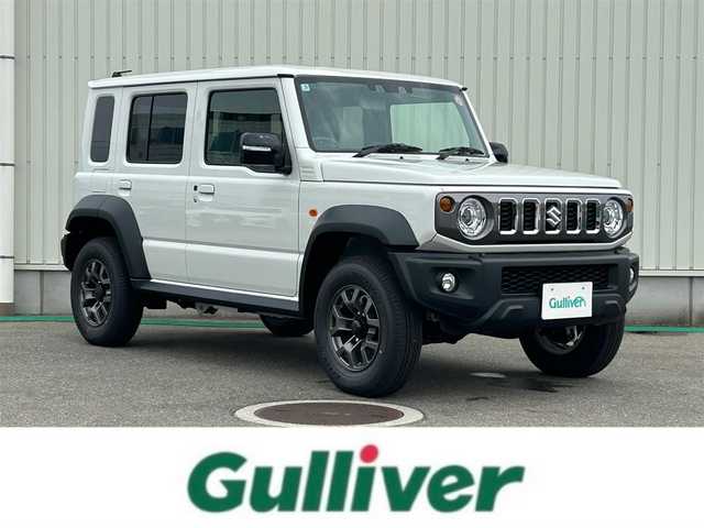 スズキ ジムニー ノマド FC 富山県 2025(令7)年 0.1万km未満 アークティックホワイトパール ワンオーナー/4WD/デュアルカメラブレーキサポート/レーダークルーズコントロール/クリアランスソナー/レーンキープアシスト/ダウンヒルアシストコントロール/オートマチックハイビーム/アイドリングストップ/助手席運転席シートヒーター/純正AW/スペアキー