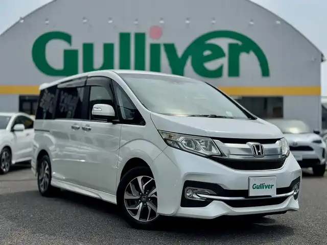 ホンダ ステップワゴン スパーダ 滋賀県 2015(平27)年 16.6万km ホワイトオーキッドパール ワンオーナー/純正9インチフルセグナビ/　フルセグ Bluetooth CD DVD SD FM AM/バックカメラ/純正フリップダウンモニター/Honda SENSING/衝突軽減ブレーキ〈CMBS〉/ACC〈アダプティブ・クルーズ・コントロール〉/LKAS〈車線維持支援システム〉/路外逸脱抑制機能/誤発進抑制機能/先行車発進お知らせ機能/標識認識機能/両側パワースライドドア/LEDヘッドライト＋オートライトコントロール付/わくわくゲート/スーパーUVカット＋IRカットフロントドアガラス/コンフォートビューパッケージ/　［親水/ヒーテッドドアミラー＋フロントドア撥水ガラス］/フロントフルオートエアコン＋リアマニュアルクーラー/1列目サイド＋サイドカーテンエアバッグシステム/純正16インチアルミ/純正フロアマット/純正ドアバイザー/ETC/スマートキー×2/プッシュスタート/1.5L DOHC VTEC TURBO/