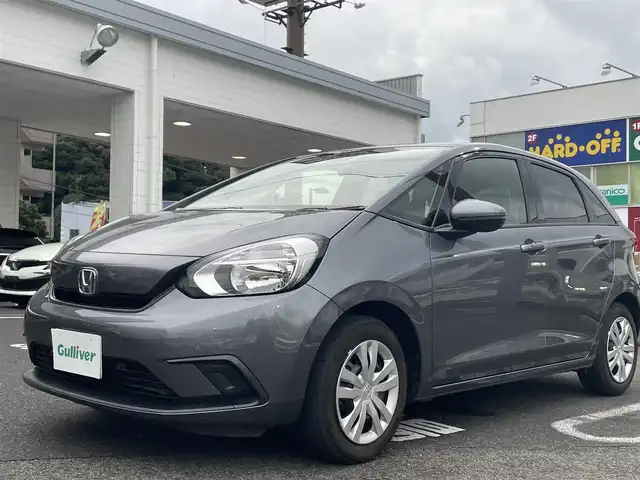 ホンダ フィット ベーシック 長崎県 2020(令2)年 6.6万km シャイニンググレーM ワンオーナー/プッシュスタート/社外SDナビ（AM/FM/DVD/SD）/ブルートゥース/ETC/クルーズコントロール（追従有）/ブレーキホールド/アイドリングストップ/USB/横滑り防止装置/衝突軽減ブレーキ/コーナーセンサー（前後）/ステアリングスイッチ/車線逸脱抑制装置/踏み間違い衝突軽減/電格ミラー/レーンキープアシスト/ブレーキホールド/スペアキー/取説/保証書