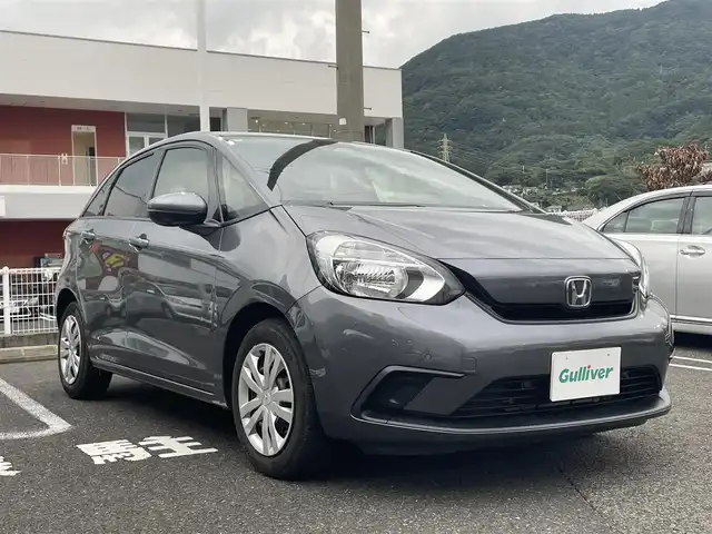 ホンダ フィット ベーシック 長崎県 2020(令2)年 6.6万km シャイニンググレーM ワンオーナー/プッシュスタート/社外SDナビ（AM/FM/DVD/SD）/ブルートゥース/ETC/クルーズコントロール（追従有）/ブレーキホールド/アイドリングストップ/USB/横滑り防止装置/衝突軽減ブレーキ/コーナーセンサー（前後）/ステアリングスイッチ/車線逸脱抑制装置/踏み間違い衝突軽減/電格ミラー/レーンキープアシスト/ブレーキホールド/スペアキー/取説/保証書