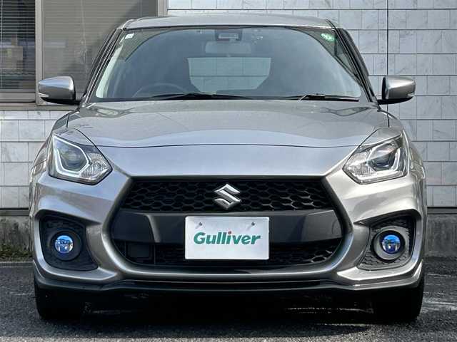 スズキ スイフト スポーツ セーフティPKG 福岡県 2018(平30)年 0.9万km プレミアムシルバーメタリック ワンオーナー/6速MT/Panasonic 8インチメモリナビ【CN-RZ846】/　(AM/FM/CD/DVD/Bluetooth/iPod/フルセグTV)/バックカメラ/スズキセーフティパッケージ/・レーザーレーダー/単眼カメラ/・デュアルセンサーブレーキサポート/・誤発進抑制機能/・車線逸脱警報/・車線逸脱抑制機能/・ふらつき警報/・先行者発進お知らせ機能/レーダークルーズコントロール/純正17インチアルミホイール/純正IPFコーティングフォグランプ/ハイドロフィリックドアミラー/スポーツ専用バケットシート/シートヒーター(運転席)/前方ドライブレコーダー/ビルトインETC/純正フロアマット/ステアリングスイッチ/USBポート/ISOFIX/スペアキー×1/保証書/取扱説明書/ナビ取扱説明書