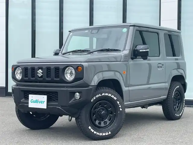 スズキ ジムニー XC 大阪府 2024(令6)年 1.4万km ミディアムグレー 社外マフラー/衝突軽減ブレーキ/リアコーナーセンサー　　/クルーズコントロール/レーンキープアシスト/ステアリングスイッチ/ダウンヒルアシストコントロール/ホワイトレタータイヤ　/ラバーマット　/革巻ステアリング　/ヒーターミラー　/前席シートヒーター/ＥＴＣ　/ＬＥＤヘッドランプ