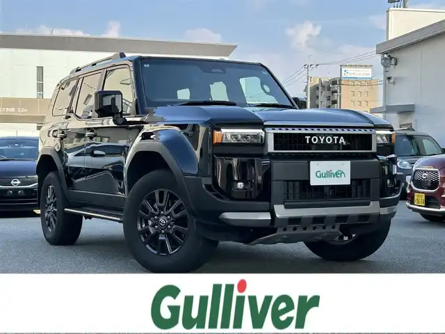 トヨタ ランドクルーザー ２５０ VX 福岡県 2024(令6)年 1.9万km ブラック ワンオーナー/純正メーカーナビ【AM/FM/BT/フルセグTV】/モデリスタエアロ/サンルーフ/レーダークルーズコントロール/アラウンドビューモニター/ブラインドスポットモニター/トヨタチームメイト/TOYOTA　SAFETY　SENSE/-プリクラッシュセーフティ/-レーントレーシングアシスト/-レーンディパーチャーアラート/-アダプティブハイビームシステム／オートマチックハイビーム/-ロードサインアシスト/-ドライバー異常時対応システム/-プロアクティブドライビングアシスト/-発進遅れ告知機能：先行車/-緊急時操舵支援（アクティブ操舵機能付）/-フロントクロストラフィックアラート/-レーンチェンジアシスト/ビルトインETC2.0/運転席・助手席シートヒーター/運転席・助手席エアシート/運転席パワーシート/デジタルインナーミラー/電動リアゲート/保証書/取扱説明書