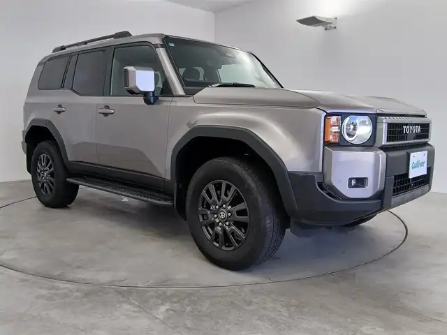 トヨタ ランドクルーザー ２５０ VX 愛知県 2024(令6)年 2.3万km アバンギャルドブロンズメタリック トヨタセーフティーセンス/　・プリクラッシュセーフティ/　・レーントレーシングアシスト/　・レーンディパーチャーアラート/　・レーダークルーズコントロール/　・オートマチックハイビーム/　・ロードサインアシスト/　・ドライバー異常時対応システム/　・プロアクティブドライビングアシスト/　・発信遅れ告知機能/サンルーフ/ブラインドスポットモニター/純正12.3インチナビ/（Bluetooth/フルセグTV/HDMI/USB/）/全方位カメラ/ETC2.0/ドライブレコーダー/デジタルインナーミラー/電動リアゲード/純正フロアマット/合皮シート/シートヒーター/シートクーラー/ステアリングヒート/ステアリングリモコン/LEDライト/ルーフレール/MTモード付AT/スマートキー/オートライト