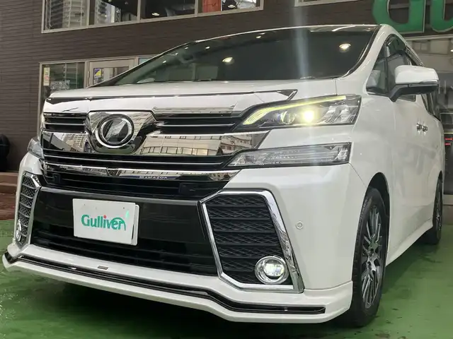トヨタ ヴェルファイア Z Gエディション 神奈川県 2016(平28)年 8.9万km ホワイトパールクリスタルシャイン JBLサウンドシステム/純正10型ナビ/・AM/FM SD CD BT フルセグTV/レーダークルーズコントロール/nanoeオートエアコン/両側電動スライドドア/パワーバックドア/電動パーキングブレーキ/オートブレーキホールド/アラウンドビューカメラ/ETC/インテリジェントクリアランスソナー/ハーフレザーシート/助手席パワーオットマン/ステアリングヒーター/LEDヘッドライト/LEDイルミネーション/後席サンシェード/自動防眩ミラー