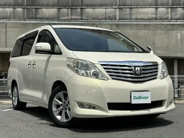 トヨタ アルファード 350G 愛知県 2008(平20)年 8.7万km ゴールドパールクリスタルシャイン 純正HDDナビ/フルセグTV・CD・DVD・SD・Bluetooth/純正フリップダウンモニター/両側パワースライドア/前席パワーシート/運転席メモリー機能付きパワーシート/ウッドコンビステアリング/助手席・二列目オットマン/クルーズコントロール（追従無し）/コーナーセンサー/ステアリングスイッチ/ビルトインETC/HIDヘッドライト(オートライト)/フォグランプ/スマートキー/プッシュスタート/横滑り防止/純正フロアマット/純正ドアバイザー/保証書