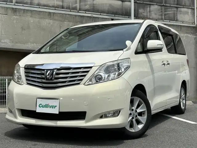 トヨタ アルファード 350G 愛知県 2008(平20)年 8.7万km ゴールドパールクリスタルシャイン 純正HDDナビ/フルセグTV・CD・DVD・SD・Bluetooth/純正フリップダウンモニター/両側パワースライドア/前席パワーシート/運転席メモリー機能付きパワーシート/ウッドコンビステアリング/助手席・二列目オットマン/クルーズコントロール（追従無し）/コーナーセンサー/ステアリングスイッチ/ビルトインETC/HIDヘッドライト(オートライト)/フォグランプ/スマートキー/プッシュスタート/横滑り防止/純正フロアマット/純正ドアバイザー/保証書