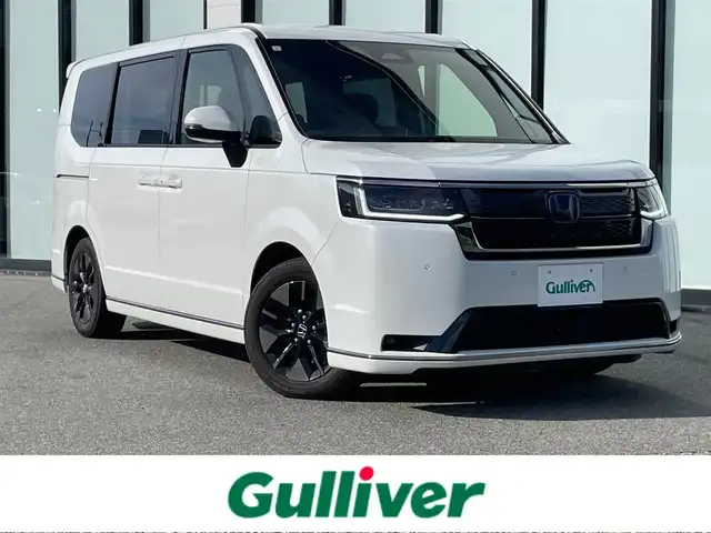 ホンダ ステップワゴン スパーダ eHEV 大阪府 2023(令5)年 3.4万km プラチナホワイトパール ホンダセンシング/クルーズコントロール/ブラインドスポットモニター/両側パワースライドドア/パワーテールゲート/純正11.4インチメモリーナビ/Bluetooth/CD/DVD/フルセグTV/USB/バックカメラ/純正10.1インチフリップダウンモニター/シートヒーター/オットマン/ビルトインETC/純正フロアマット