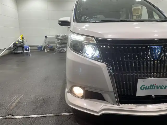 トヨタ エスクァイア ハイブリッド Gi 福島県 2016(平28)年 12.1万km ホワイトパールクリスタルシャイン ワンオーナー/アルパイン11インチナビ/CD/DVD/SD/BT/フルセグTV/アルパインフリップダウンモニター/社外17インチAW(社外AW＋冬タイヤ積込)/社外車高調ローダウン/社外フロントスポイラー/Toyota Safety Sense C/両側パワースライドドア/クルーズコントロール/合成皮革シート/シートヒーター/バックカメラ/オートハイビーム/LEDヘッドライト/ビルトインETC/プッシュスタート/ドアバイザー/フロアマット