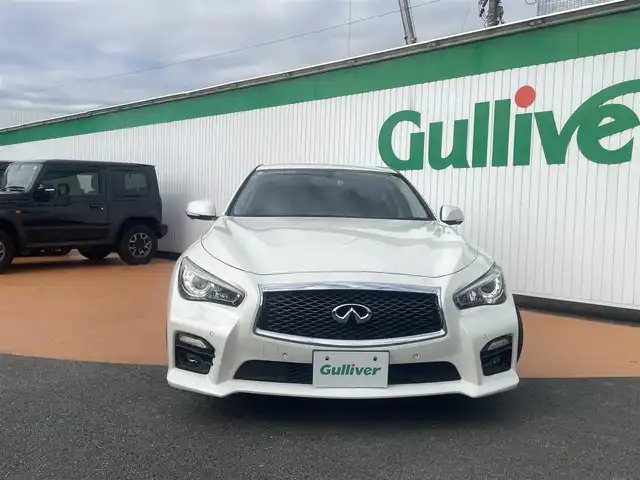 日産 スカイライン ハイブリッド 350GT Type SP 三重県 2016(平28)年 7.5万km ブリリアントホワイトパール 純正メーカーナビ/アラウンドビューモニター/全方位運転支援システム/LEDヘッドランプ/オートライト/ボディ同色電動格納ドアミラー/245/40R19タイヤ/　＊19インチアルミホイール/革巻ステアリングホイール/パドルシフト/SRSエアバック（運転席/助手席/サイド/カーテン）/左右独立温度調整機能付オートエアコン/アルミペダル/SRSダウンサス/ブラック革シート/シートヒーター（運転席/助手席）/インテリジェントキー/プッシュスタート