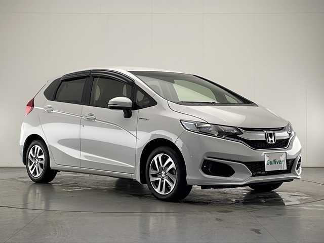 ホンダ フィット ハイブリット F 宮崎県 2018(平30)年 2.5万km プラチナホワイトパール 純正ナビ(VXM-194VFi)/CD/DVD/AM/FM/SD/BT/スマートキー　スペア１本/横滑り防止装置/アイドリングストップ/ステアリングスイッチ/電動格納ミラー/ウインカーミラー/社外アルミホイール/純正フロアマット/サイドバイザー/ETC