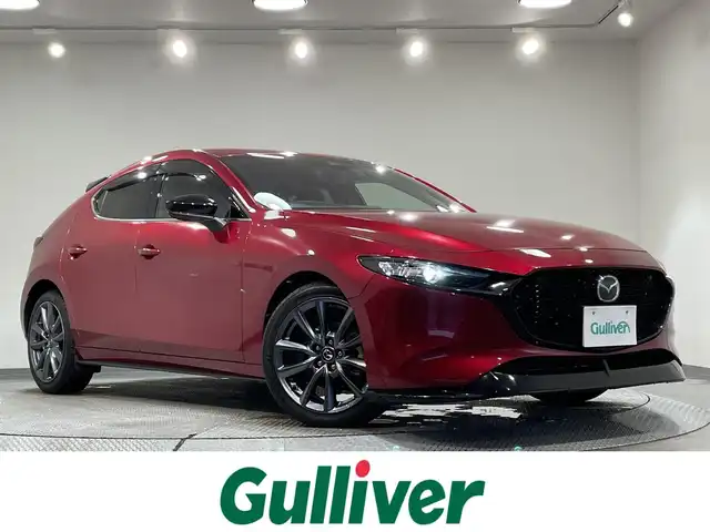マツダ マツダ３ファストバック 15S ツーリング 愛知県 2019(令1)年 3.1万km ソウルレッドクリスタルM 純正SDナビ（AM/FM/Bluetooth/ワンセグTV/USB/CD・DVD再生）/純正ドライブレコーダー/衝突軽減システム/レーダークルーズコントロール/LEDヘッドライト/ETC/バックカメラ/ブラインドスポットモニタリング/コーナーセンサー/レーンキープアシスト/パーキングセンサー/プッシュスタート/オートマチックハイビーム/スマートキー/ミュージックサーバー/ミュージックプレイヤー接続/純正フロアマット/純正アルミホイール/オートライト