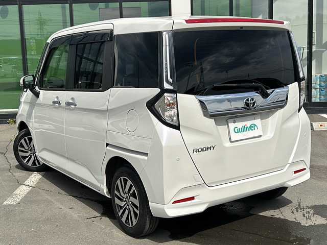 トヨタ ルーミー カスタムG 青森県 2023(令5)年 1.2万km パールホワイトⅢ ・寒冷地仕様/・４WD/・社外9インチメモリナビ/　（AM　FM　CD　DVD　TV　BT　SD）/・バックカメラ/・スマートキー/・プッシュスタート/・レーダークルーズコントロール/・純正エンジンスターター/・アイドリングストップ/・スマートアシスト/・先行車発進通知/・衝突警報/・車線逸脱警報/・ふらつき警報/・社外前後型ドライブレーコーダー/・プッシュスタート/・純正アルミホイール/・フロントフォグ/・ドアバイザー/・保証書/・取扱説明書