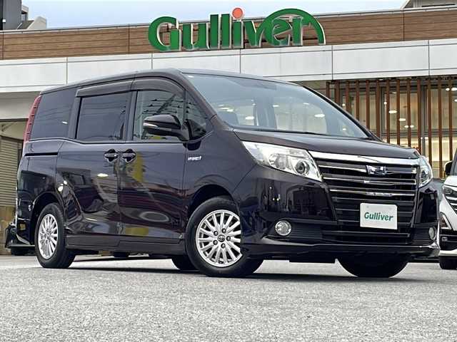 トヨタ ノア ハイブリッド G 沖縄県 2015(平27)年 18.5万km ボルドーマイカメタリック 純正ナビ・TV・Bluetooth・CD/DVD/バックカメラ/フリップダウンモニター/両側パワースライドドア/ETC/オートライト/LEDヘッドライト/シートヒーター/セーフティセンスC