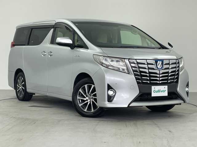 トヨタ アルファードハイブリット G 愛知県 2017(平29)年 5.4万km シルバーM /純正９インチナビ　//ＣＤ　ＤＶＤ　フルセグＴＶ　ＳＤ　ＦＭ　ＡＭ　//バックカメラ　//両側パワースライドドア　//ビルトインＥＴＣ　//ドライブレコーダー//スマートキー//スペアキー　//オットマン　//取扱説明書　//LEDオートヘッドライト//クルーズコントロール　//後席ロールサンシェード//前席パワーシート//シートメモリー//革巻きステアリング//電動パーキングブレーキ//純正フロアマット//純正ドアバイザー//215/65/R16スタッドレス付AW積込